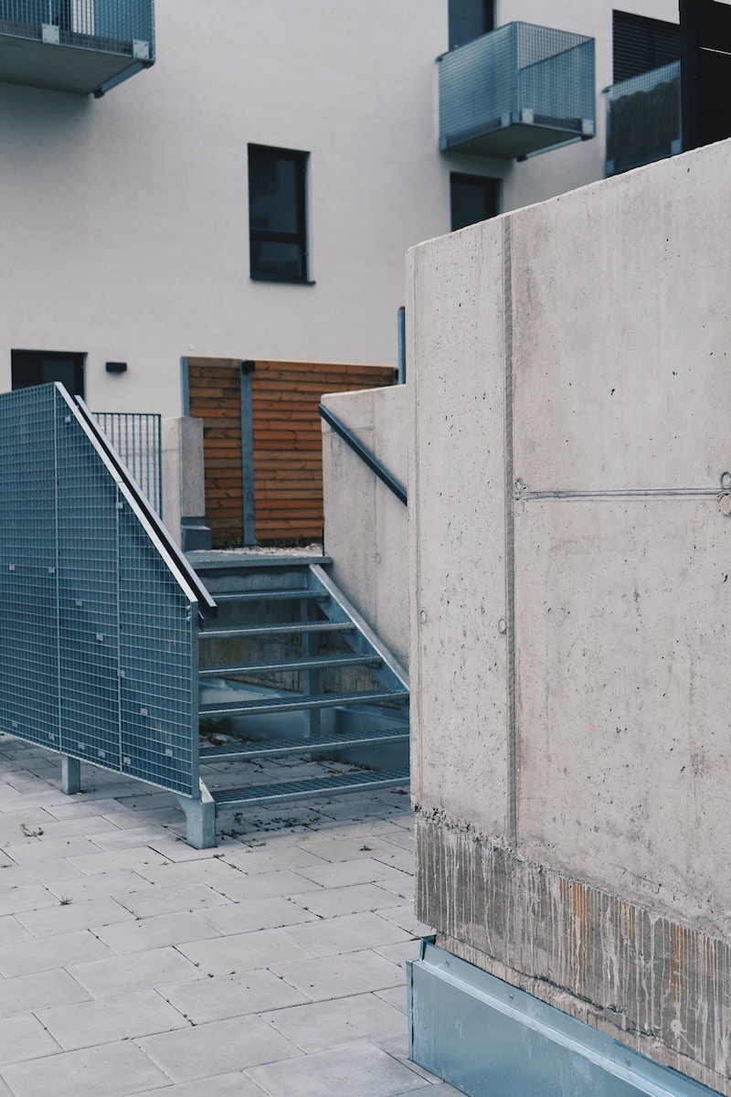 gray concrete stairs beside white concrete building